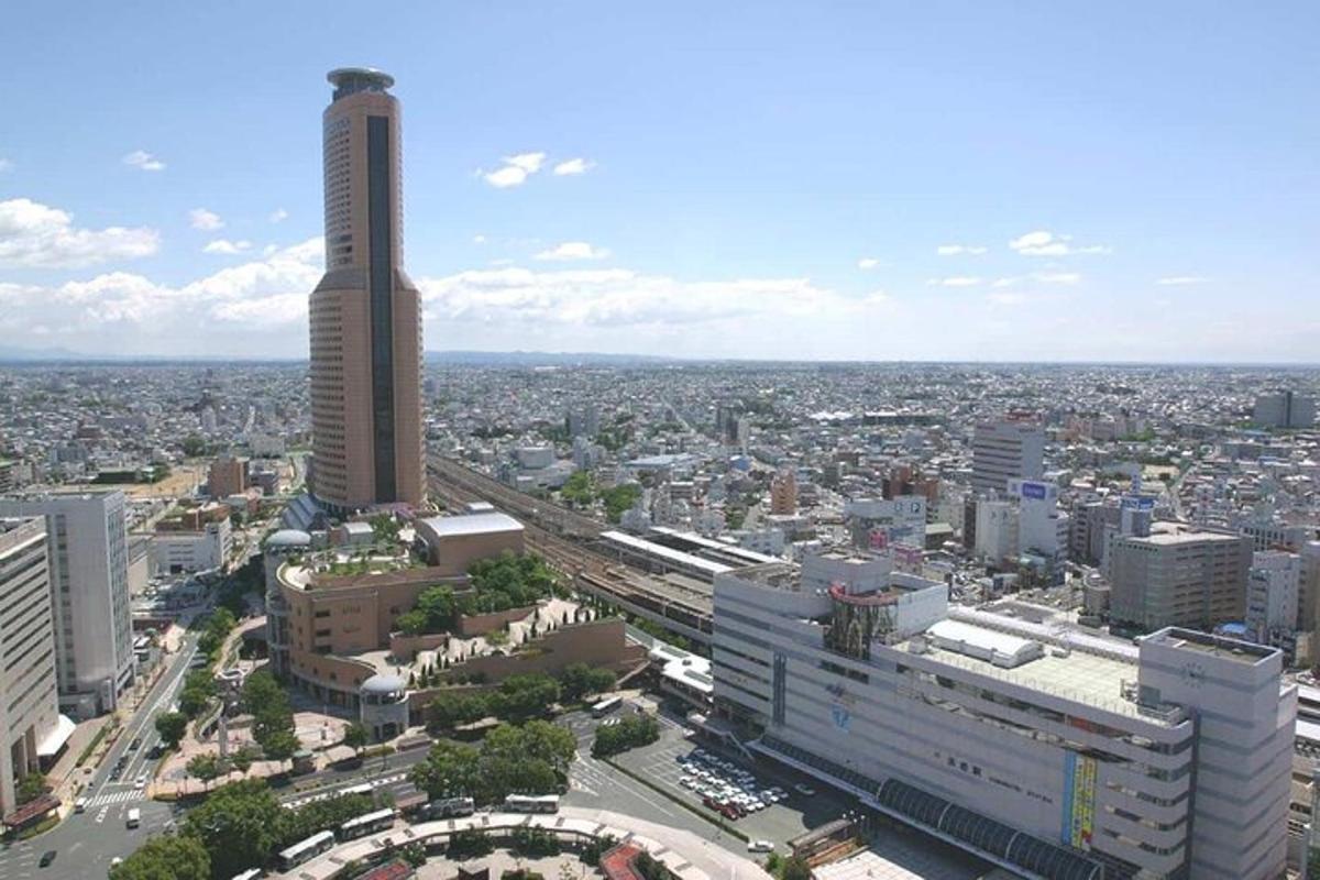 an aerial view of a city with a tall building