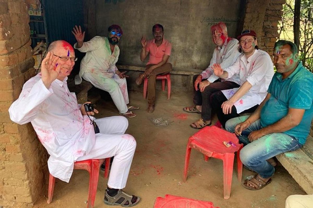 a group of people sitting on chairs with paint on their faces
