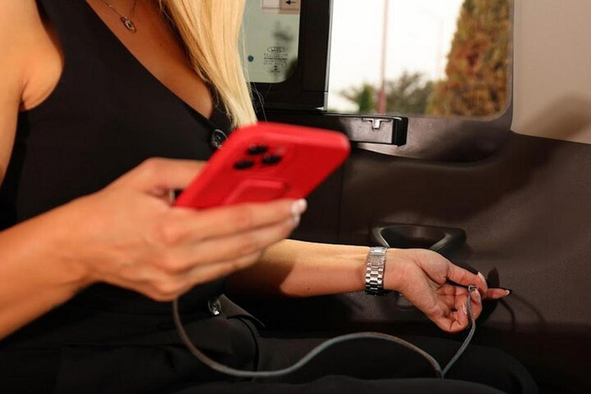 una donna che tiene in mano un cellulare rosso