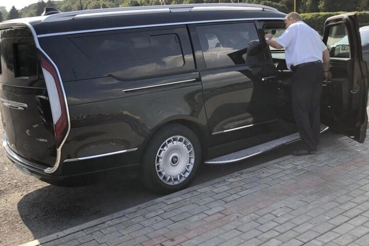 a man opening the door of a black van