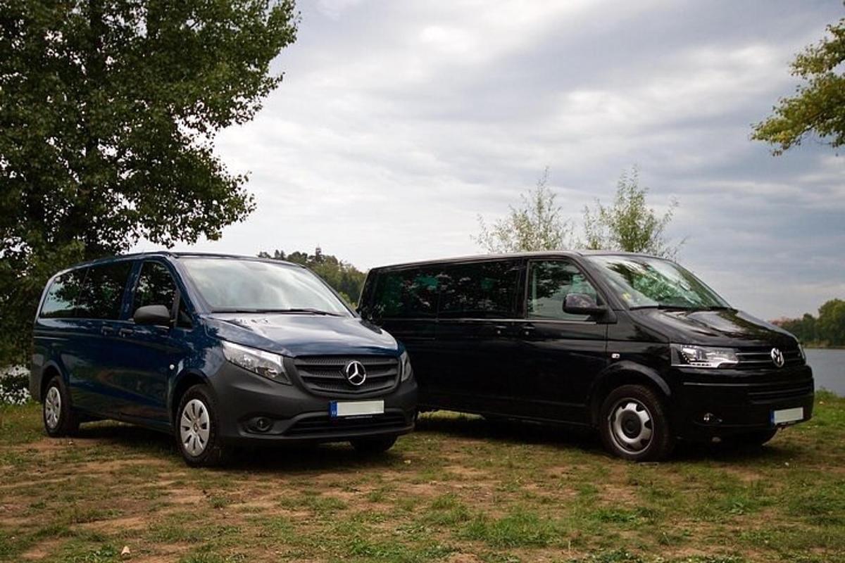 two cars parked next to each other in a field