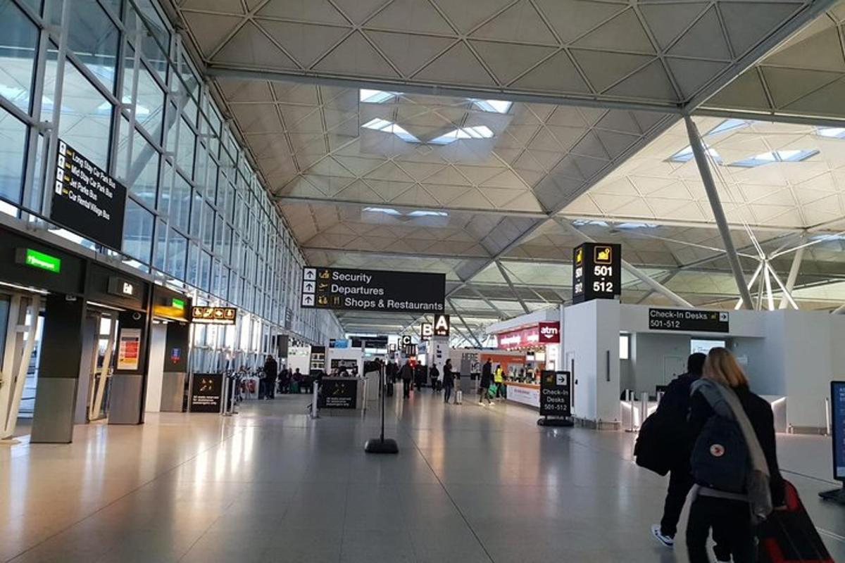 a large airport with people walking through a terminal