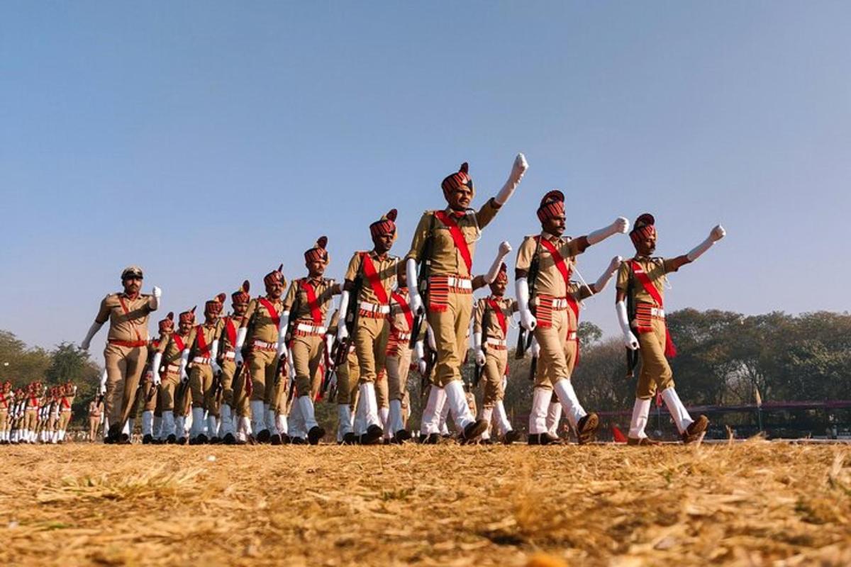 a group of men in uniform walking in a field