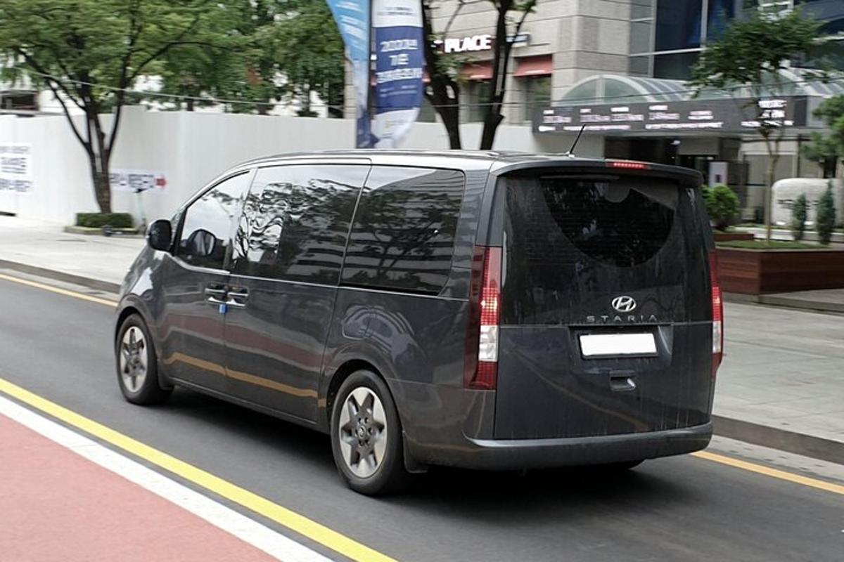 a black van is driving down a city street