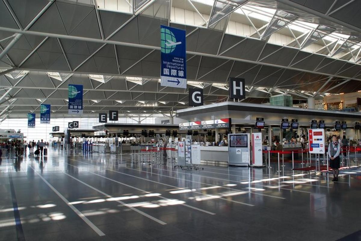 an empty airport terminal with people walking around