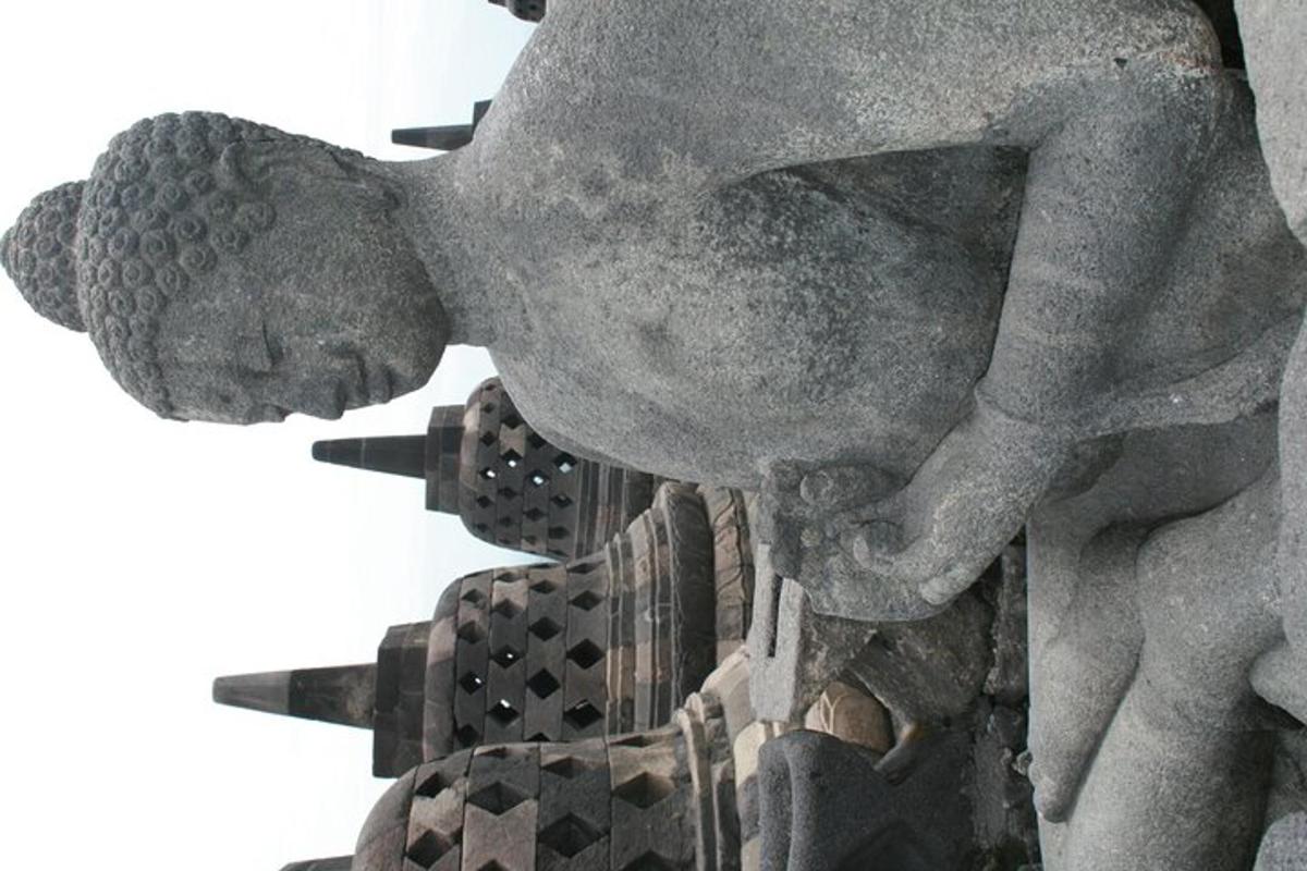 a statue of an elephant with its trunk in its mouth