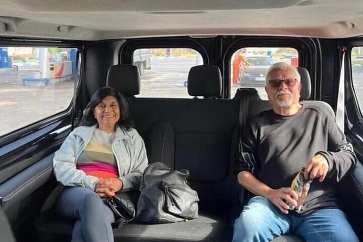 a man and a woman sitting in the back of a van