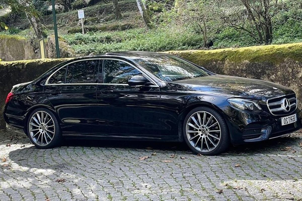 a black car parked on a brick road