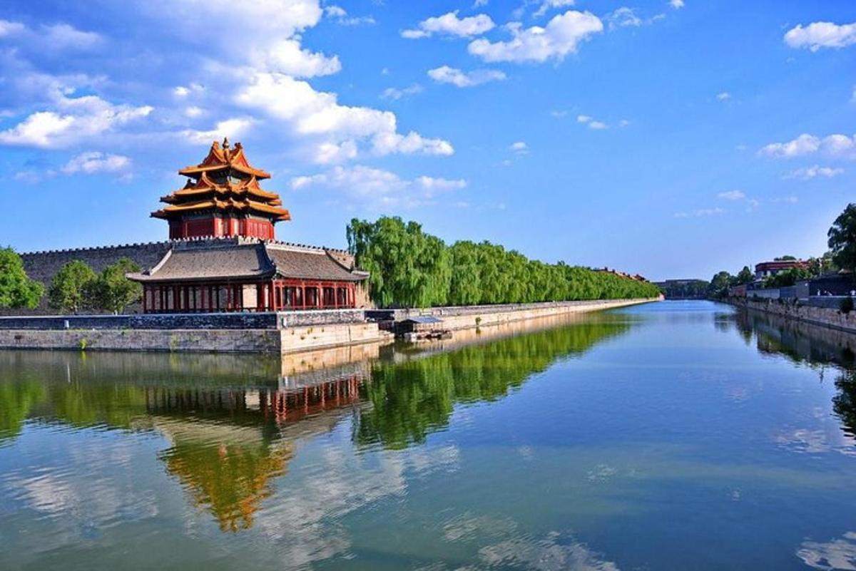a chinese building on the side of a river