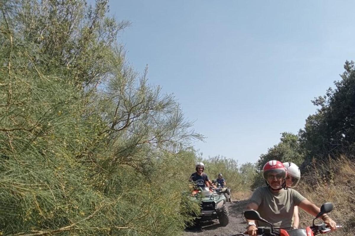 a group of people riding motorcycles on a dirt road
