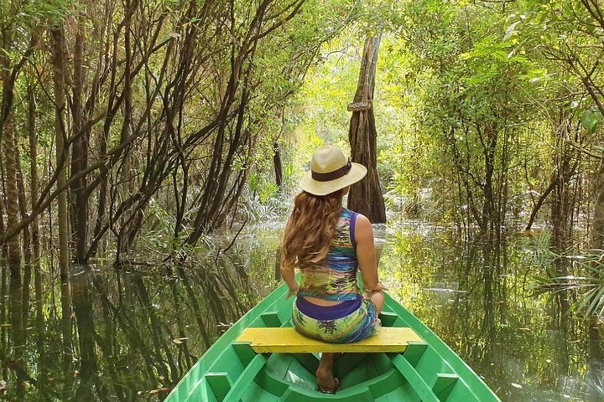 a woman sitting on a green boat in the water