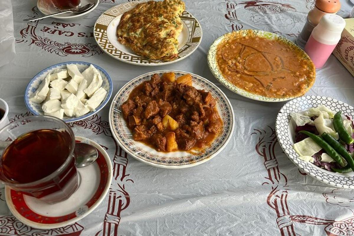 a table with plates of food and a cup of coffee