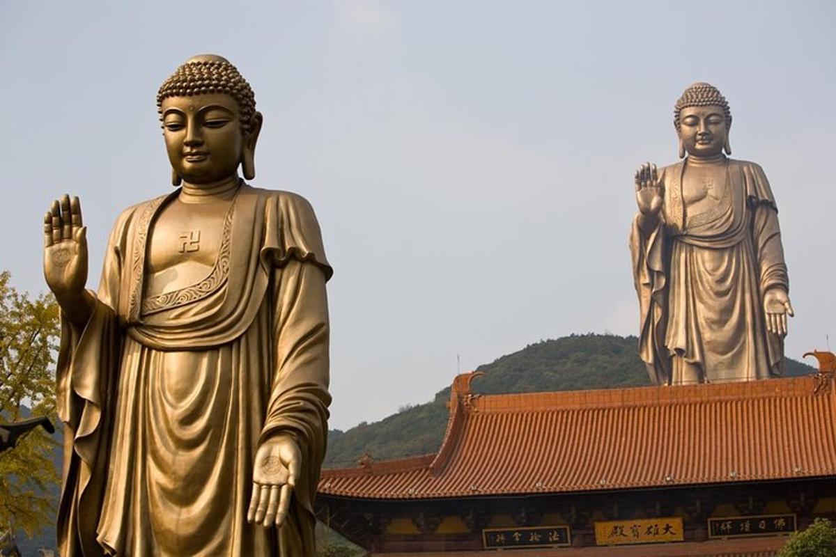two large statues standing in front of a building