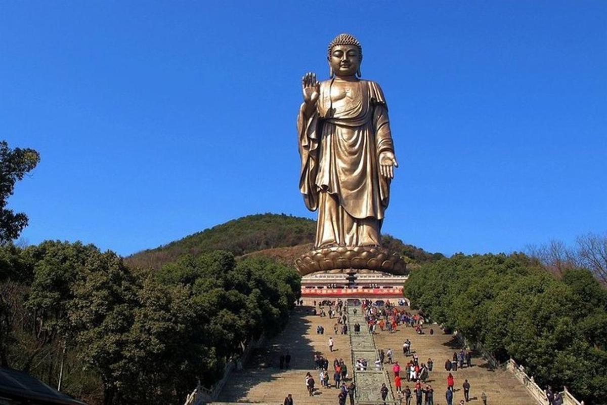 a large statue of a woman on top of a building