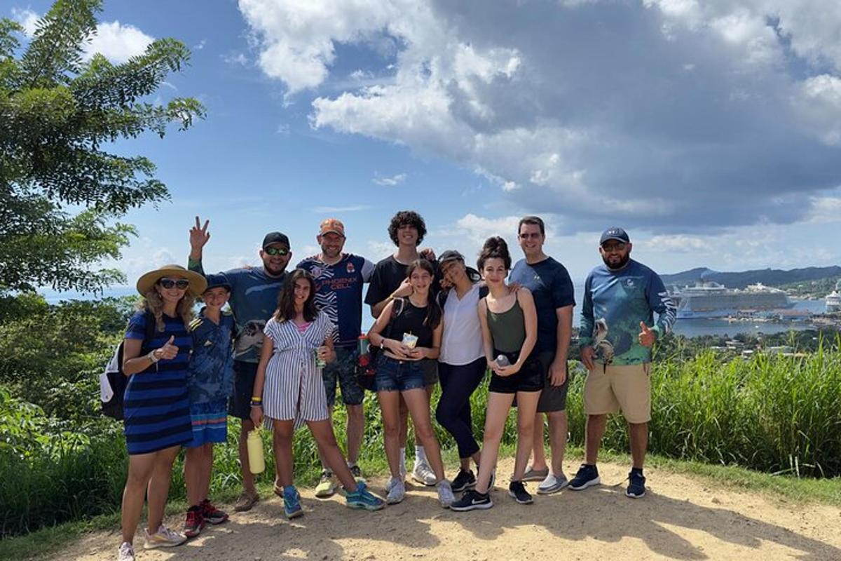 a group of people posing for a picture on a hill