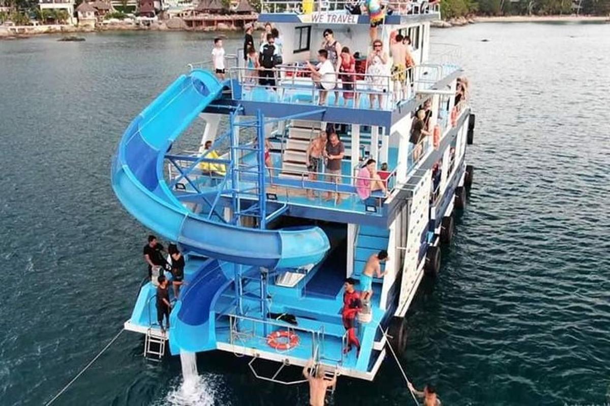 a ferry boat with a slide in the water