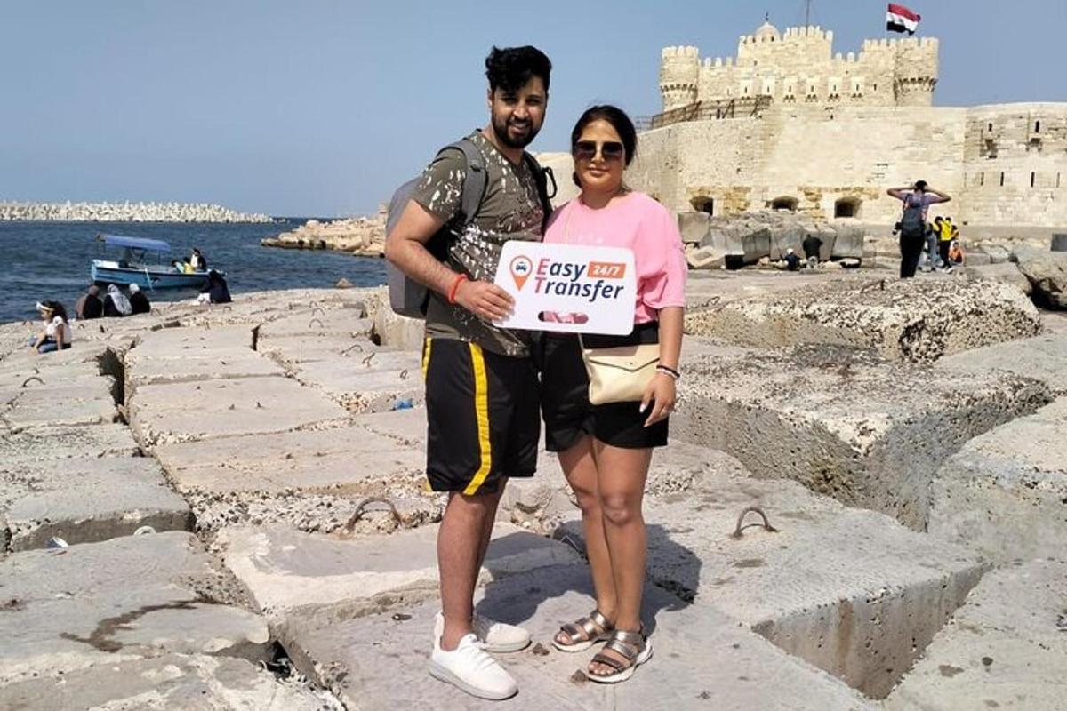 a man and a woman standing on the ruins of a castle