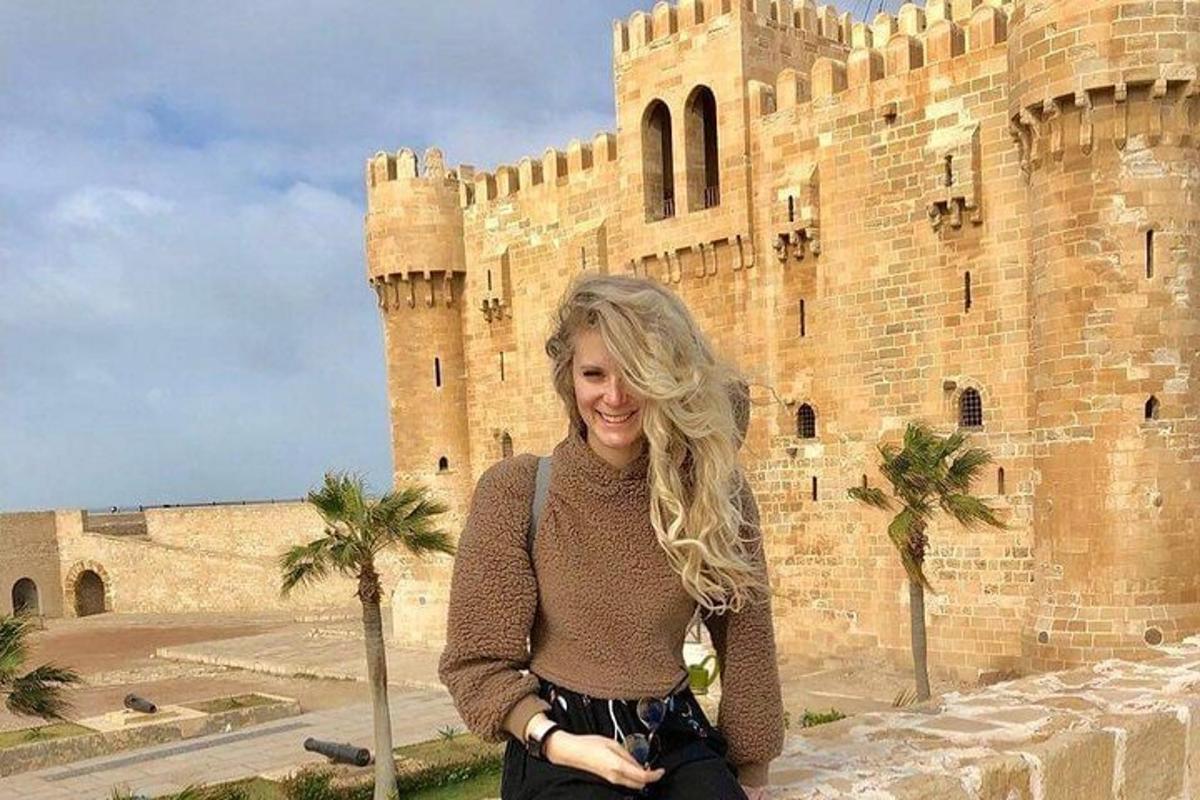 a woman standing in front of a castle