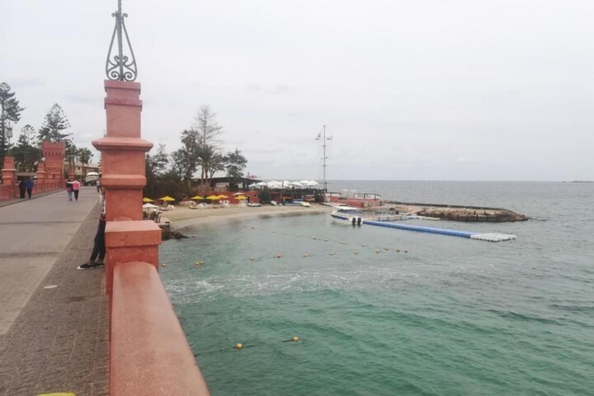 a person standing on a wall near a body of water
