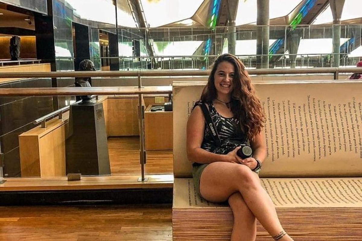 a woman sitting on a bench in a building