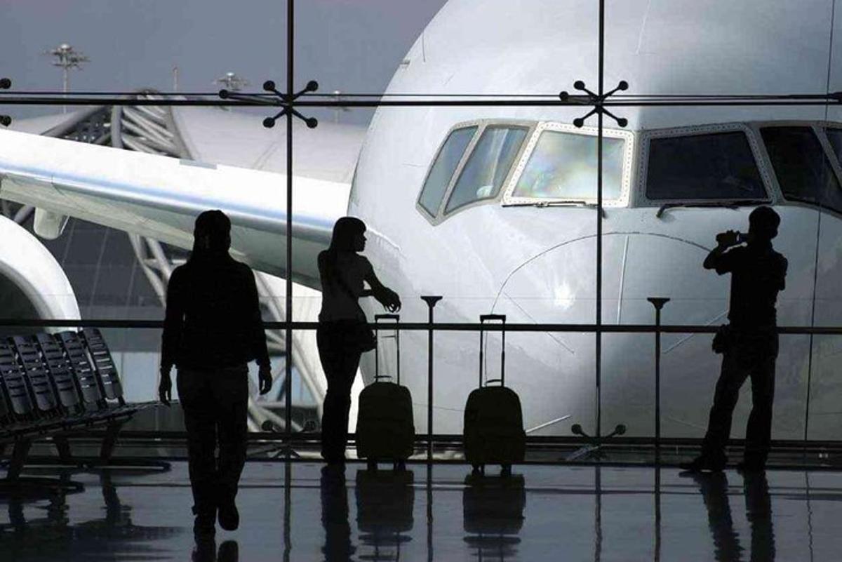a group of people standing next to an airplane