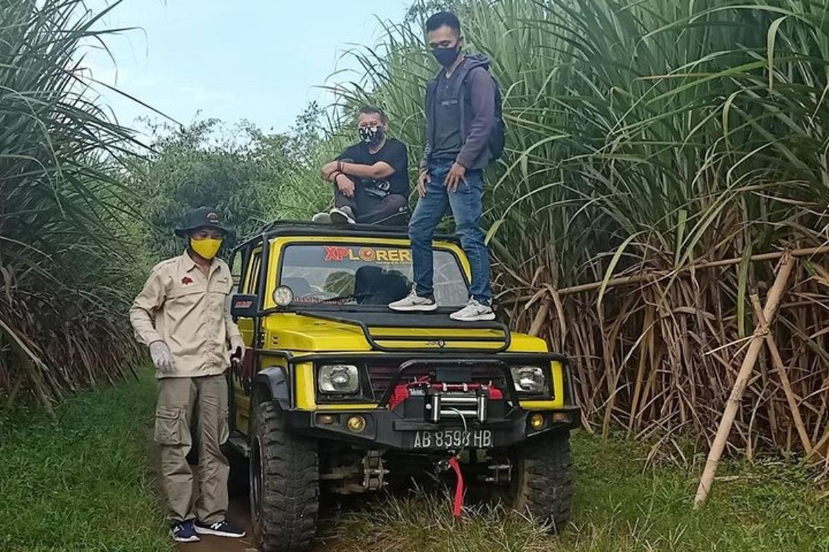 a man standing on the top of a jeep