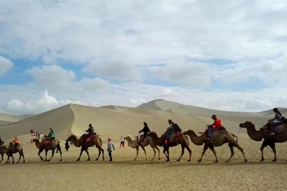 a group of people riding horses in the desert