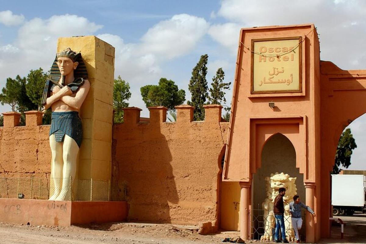 Una estatua de una mujer parada junto a una pared.