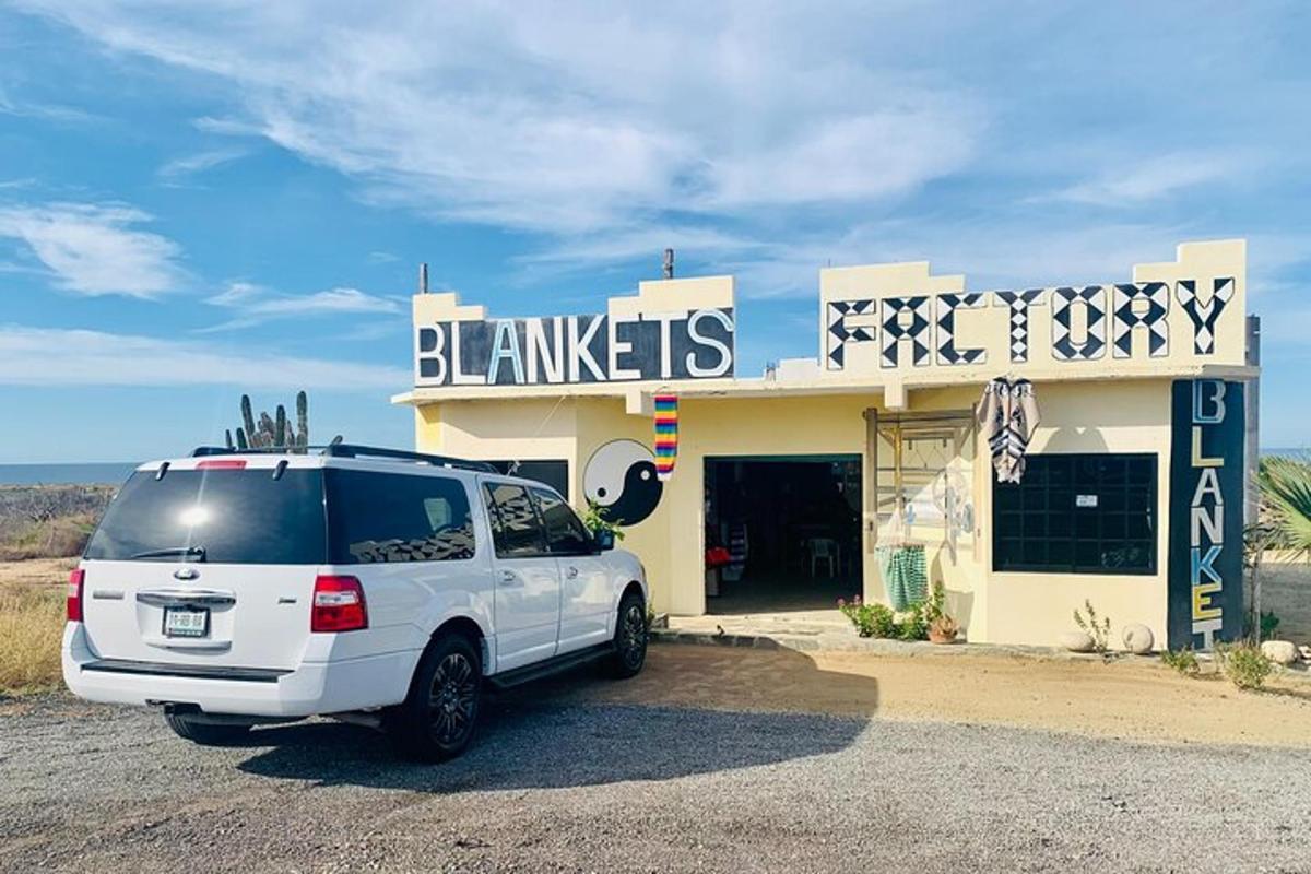 a white suv parked in front of a building