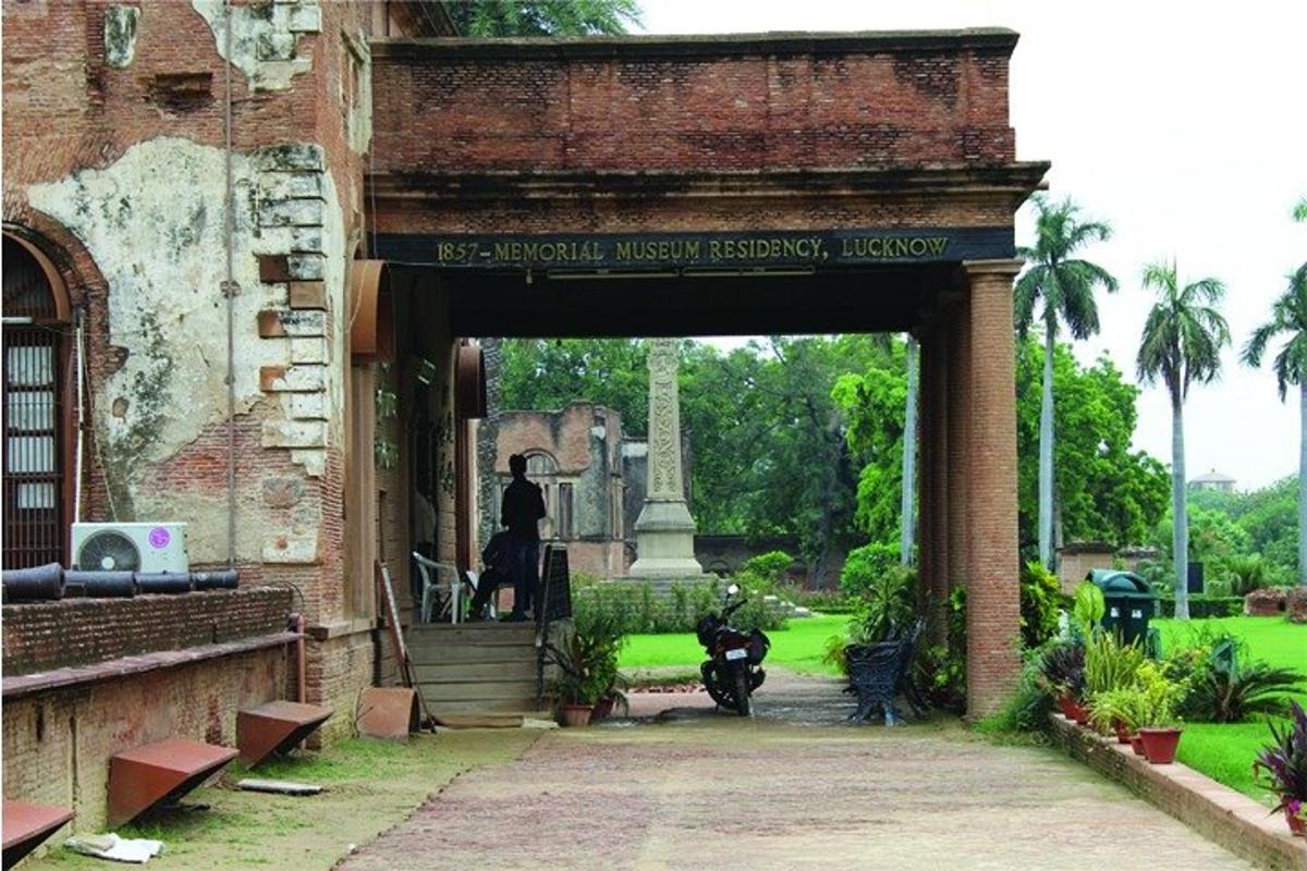 an entrance to a building with a motorcycle parked under it