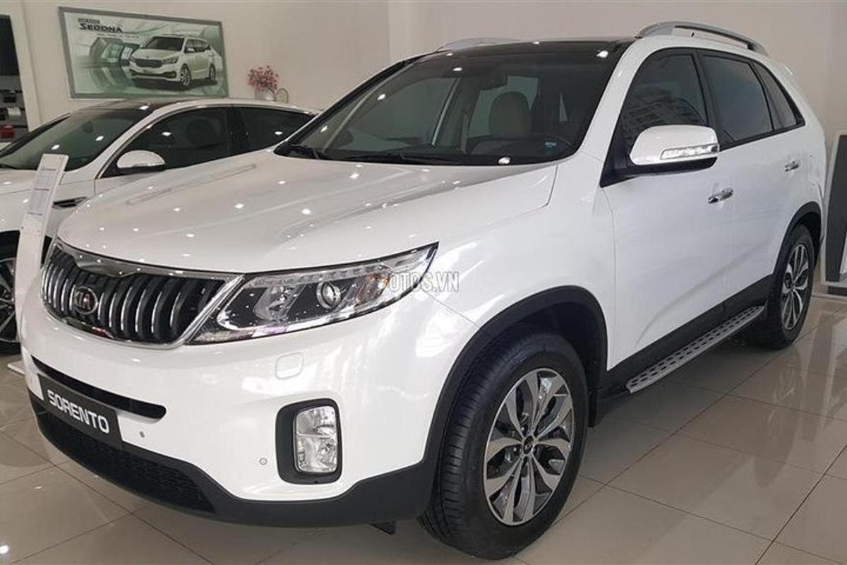 a white suv parked in a show room