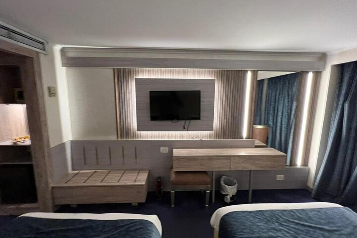 a hotel room with two beds and a television