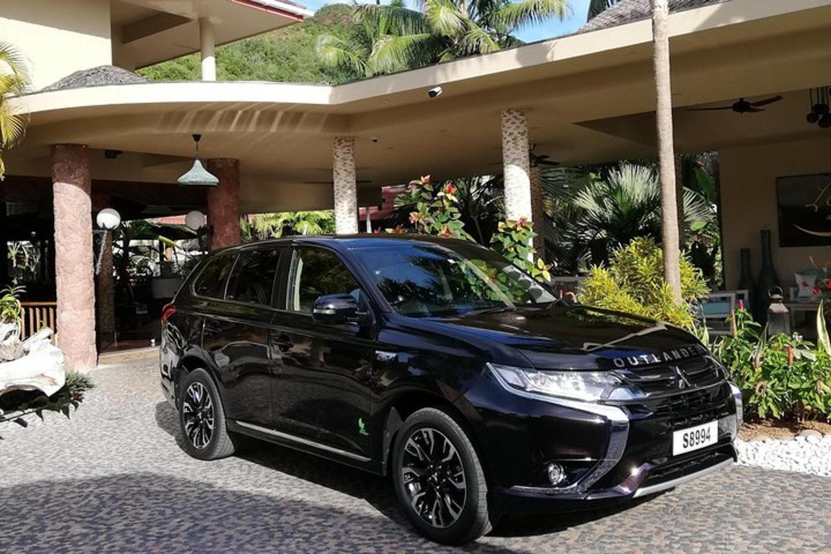 a black car parked in front of a house