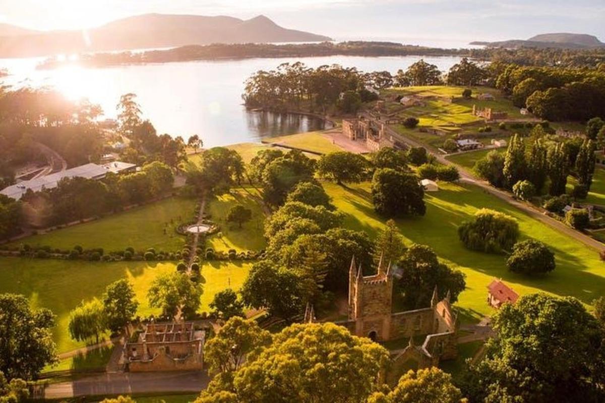 an aerial view of a park next to a river