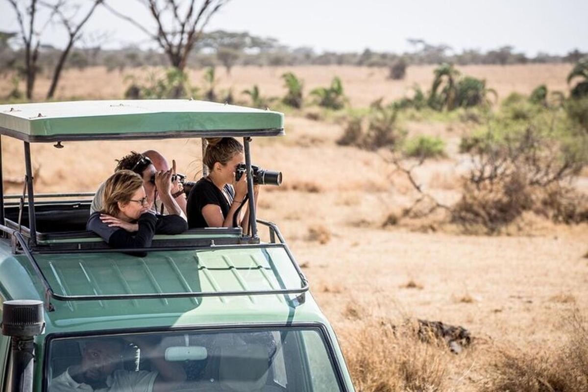 a group of people riding in a safari vehicle