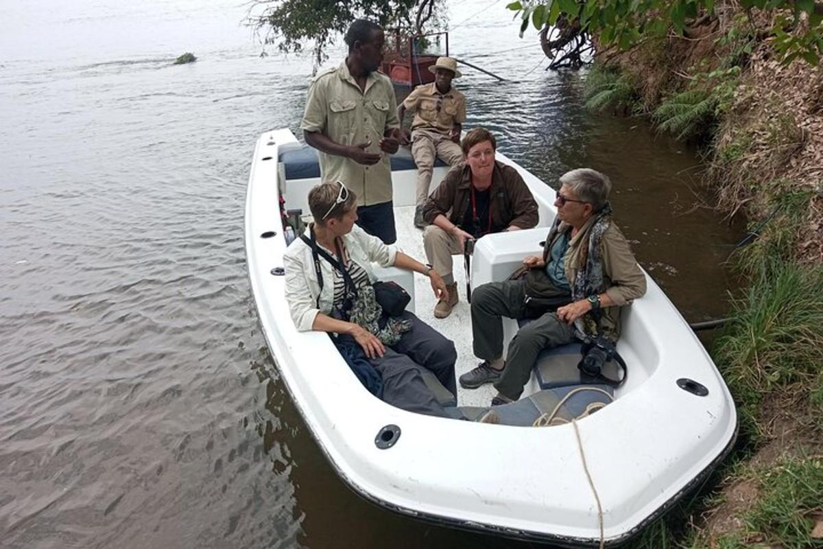 a group of people sitting in a boat on the water
