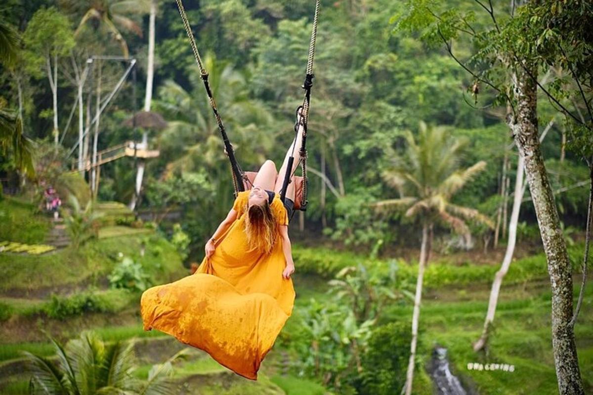 a woman in a yellow dress swinging on a swing