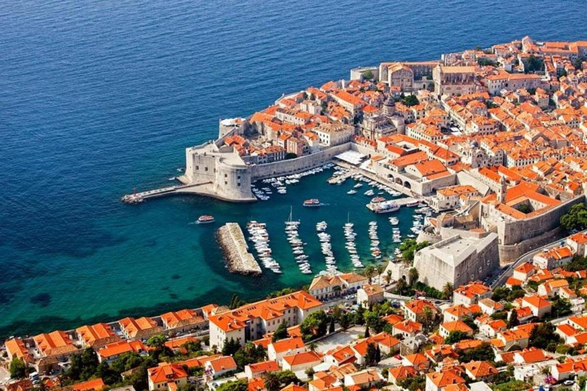 an aerial view of a city with boats in the water