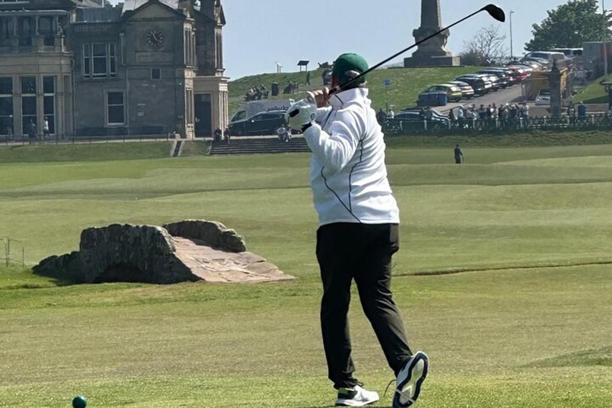 mies heiluttelee golfmailaa golfkentällä