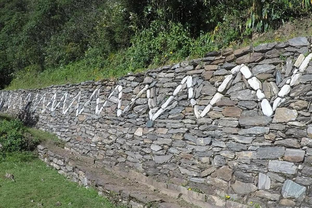 un mur de pedra amb escrits blancs