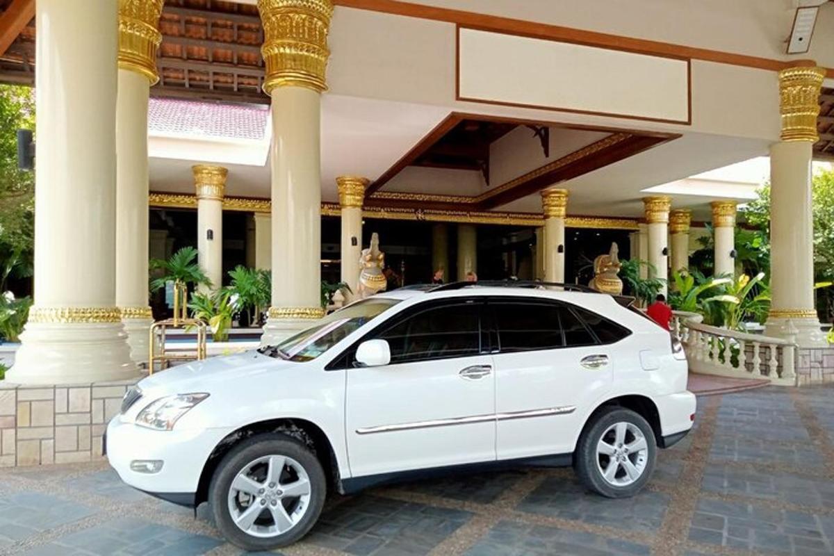 a white car parked in front of a building