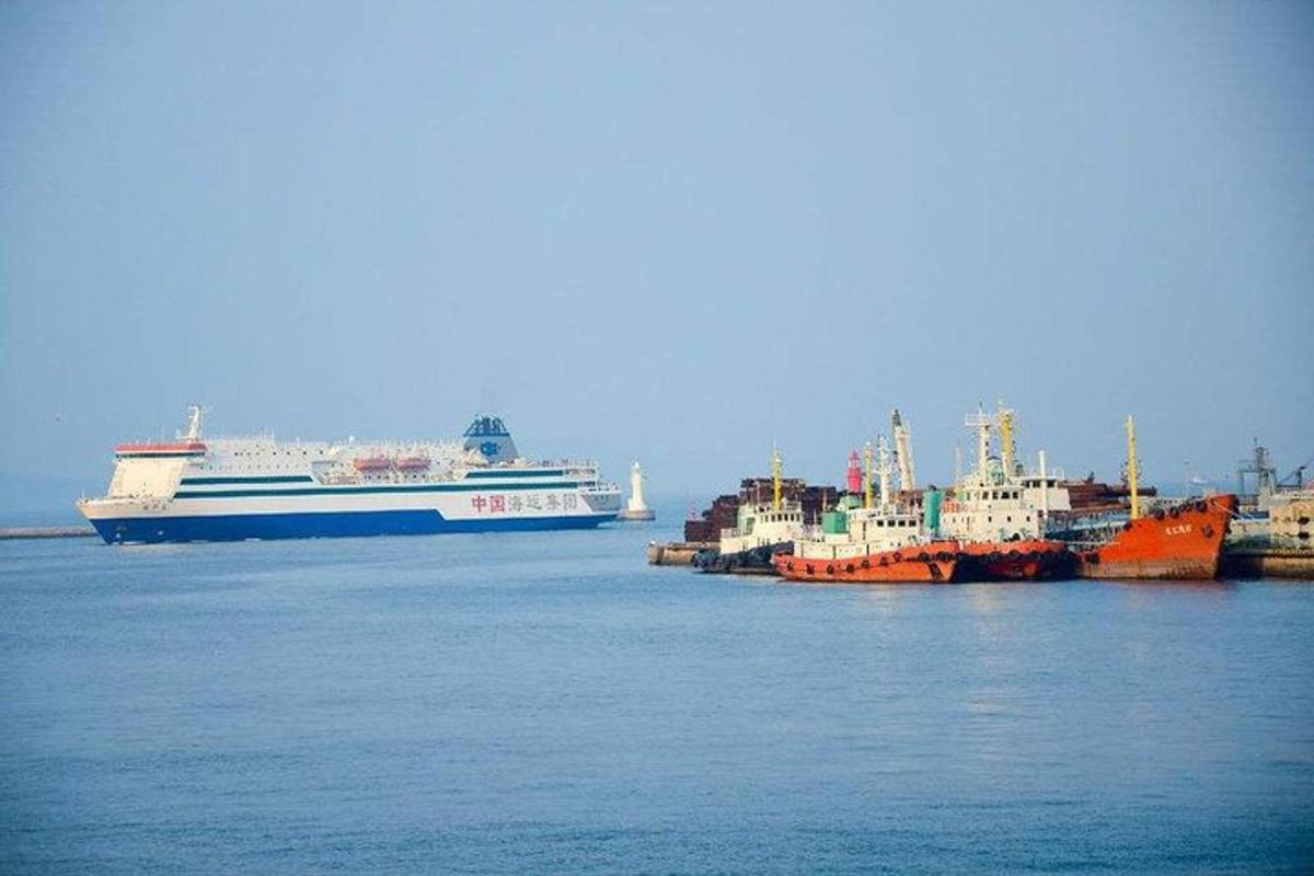 three ships are docked in a harbor with a cruise ship