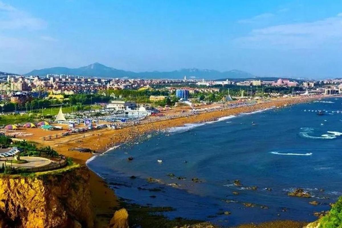 a view of a beach with a city in the background