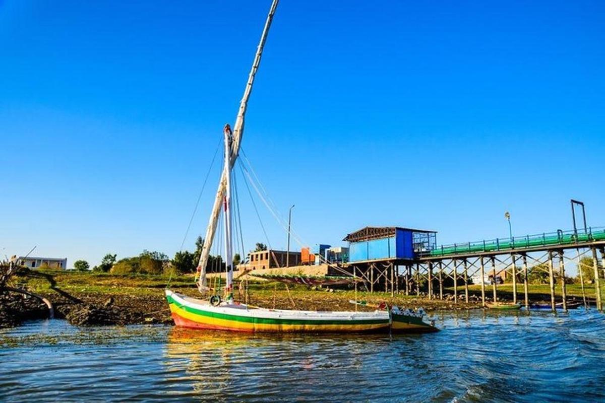 a boat sitting in the water next to a dock