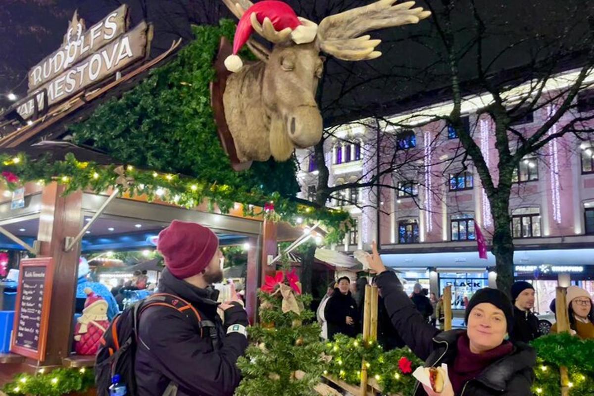 a group of people standing in front of a christmas display