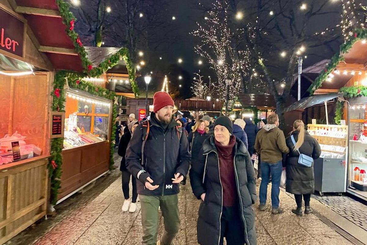 a group of people walking through a christmas market