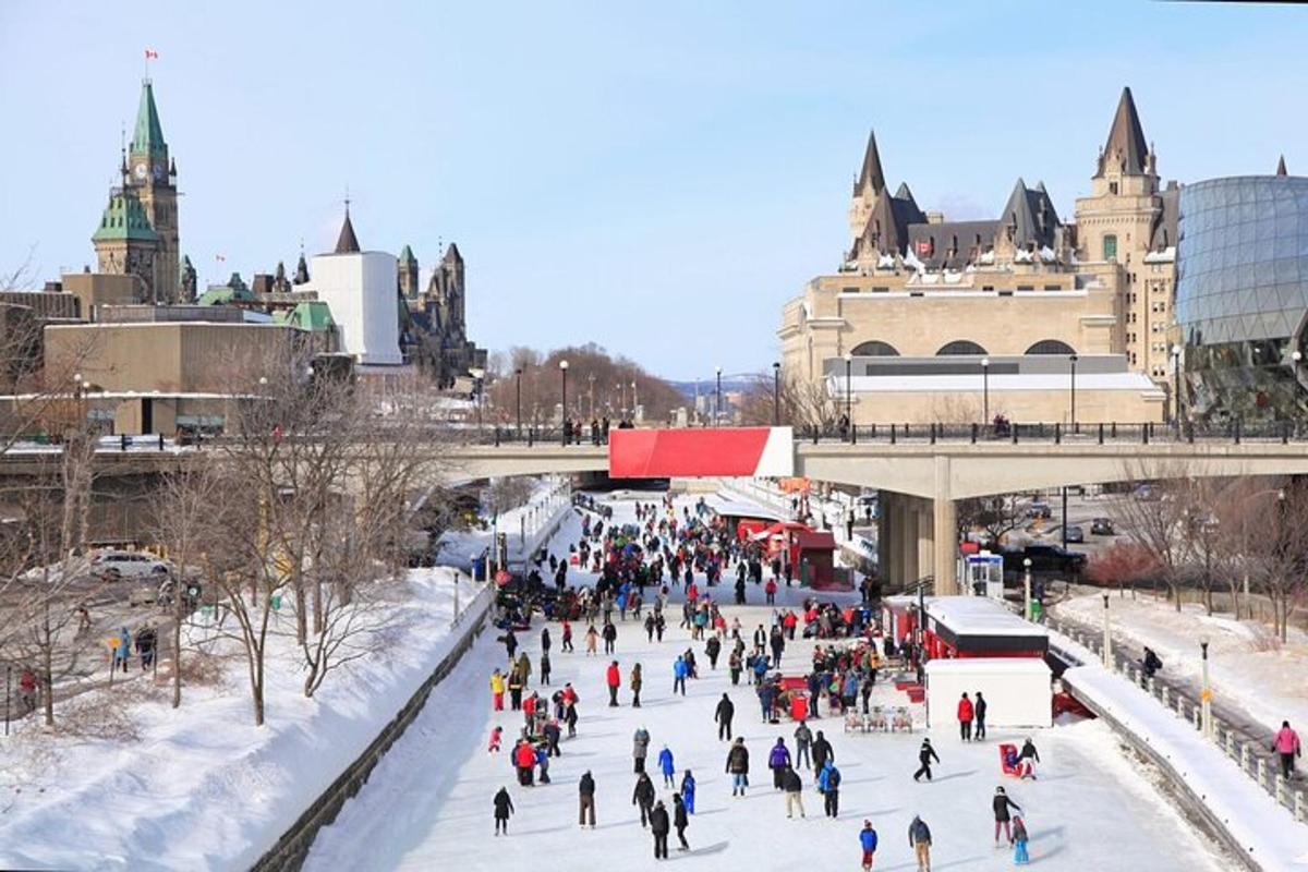 a group of people skating on the ice in a city