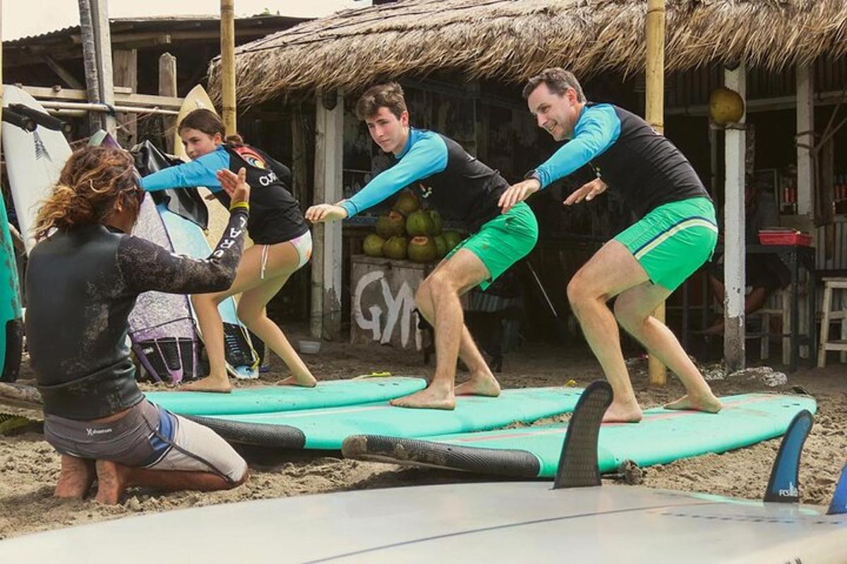 a group of people standing on surfboards on the beach