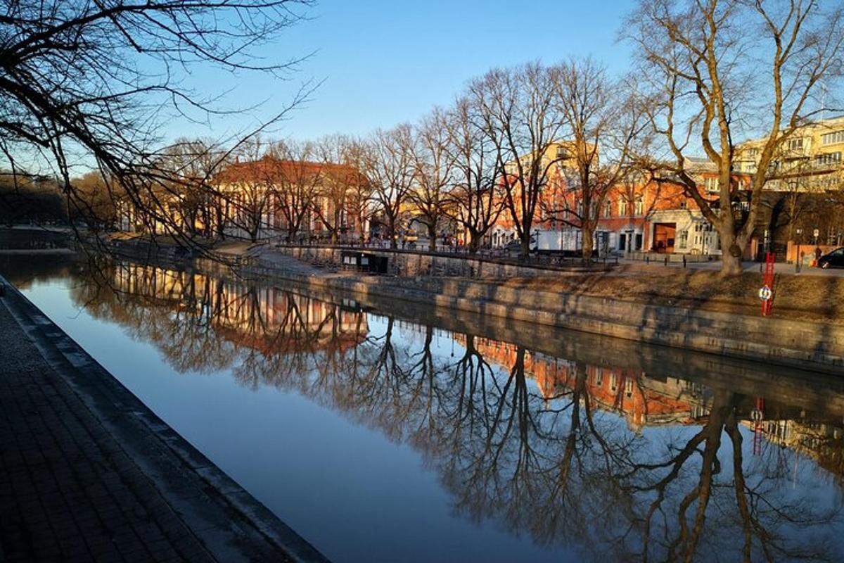 a river with reflections of trees in the water