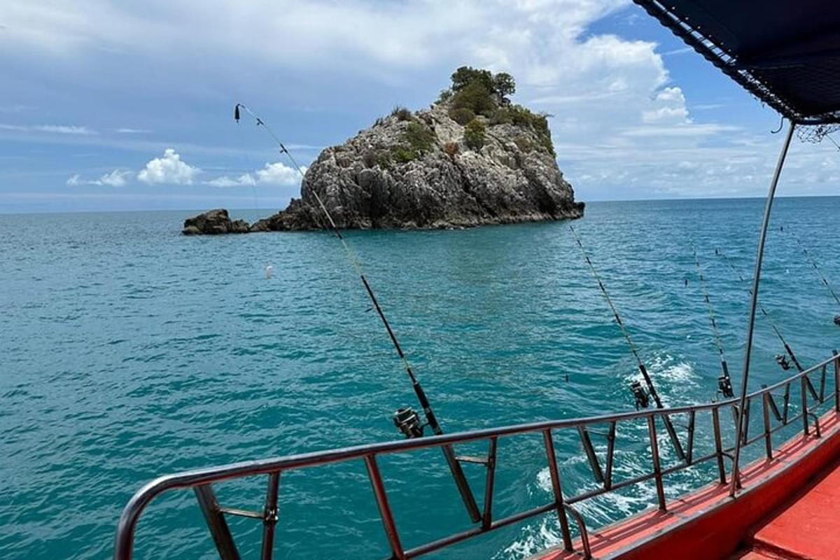a boat in the ocean with a small island
